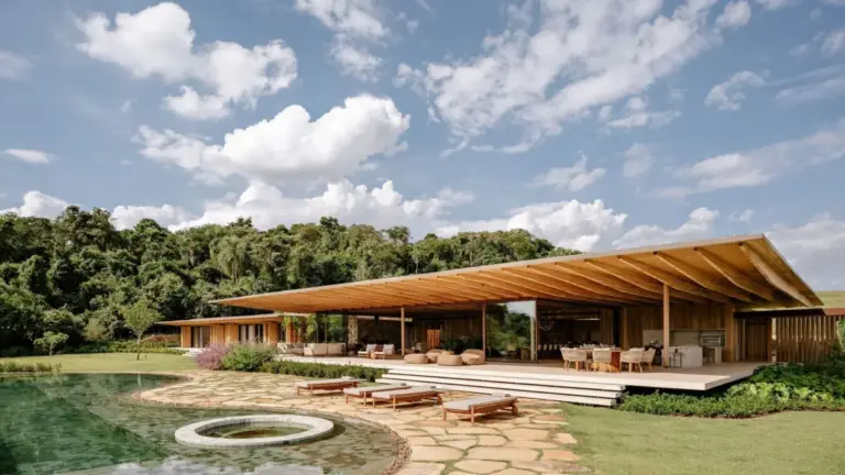 Jacobsen Arquitetura Designs AMS House as a Fragmented Residential Composition Along Sloping Forest Terrain